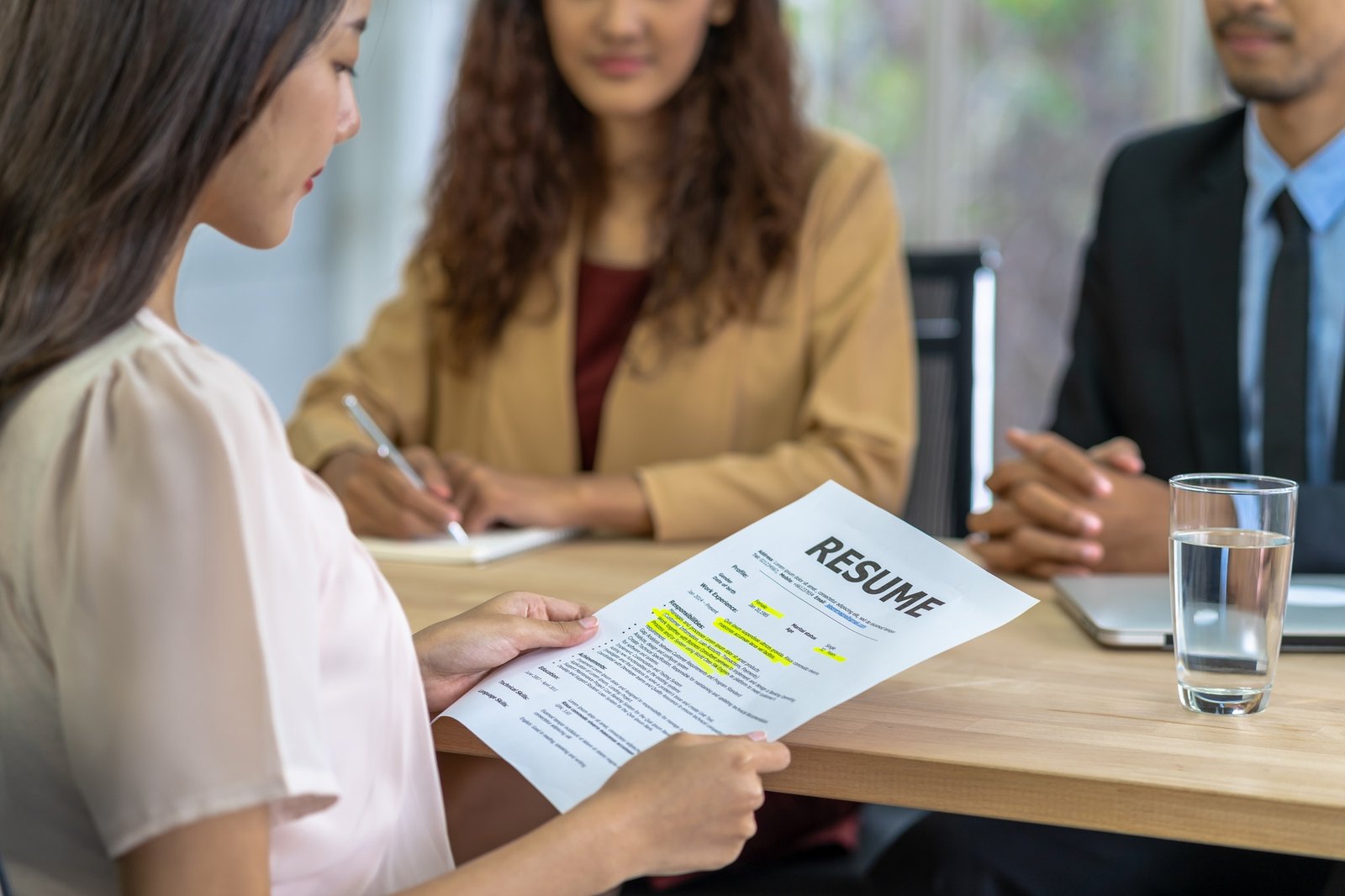 Young Asian woman graduate holding the resume document and preparing